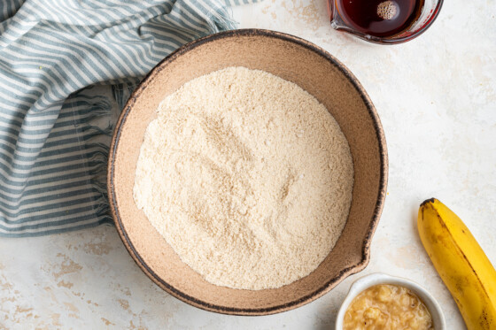 Oat flour and almond flour in a large tan mixing bowl.