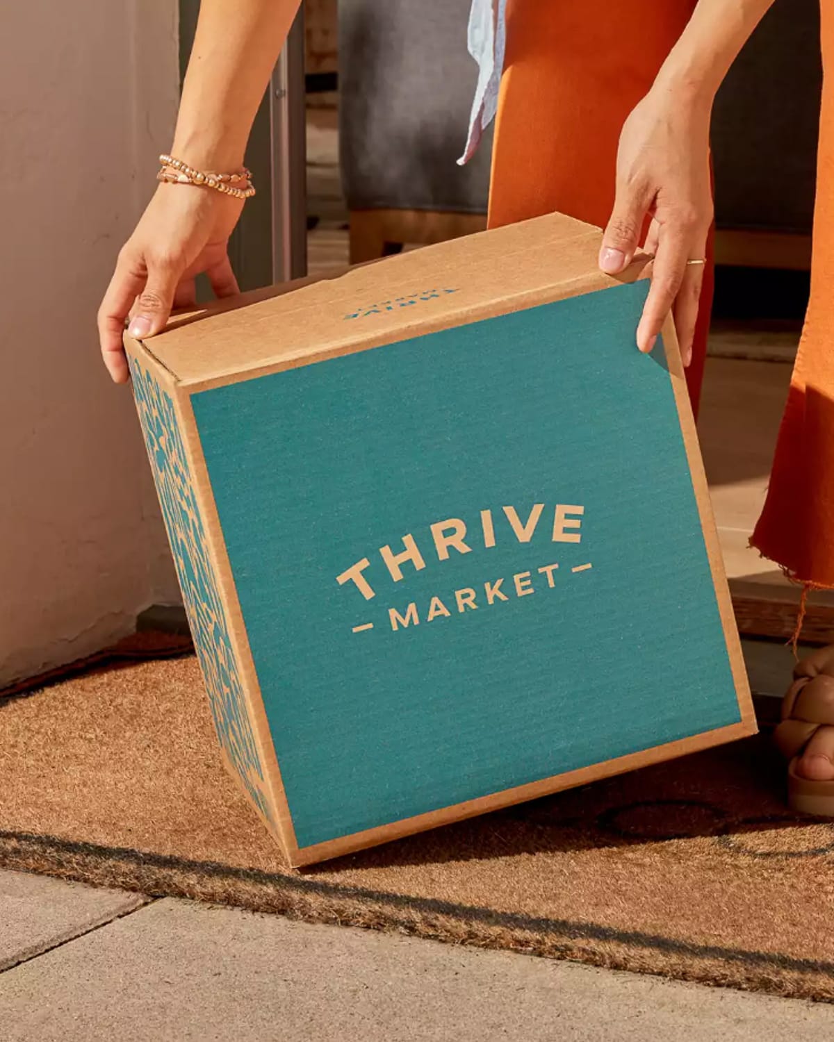 Woman holding Thrive Market box.