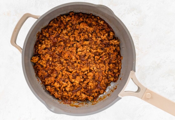 Ground turkey taco mixture simmering in skillet.