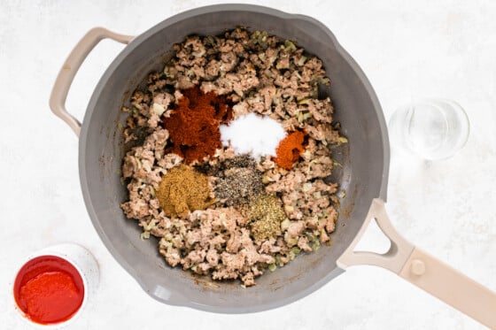 Spices added to the ground turkey mixture in skillet before mixed together.