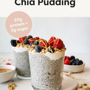 protein chia pudding with berries, granola and nut butter in clear glass