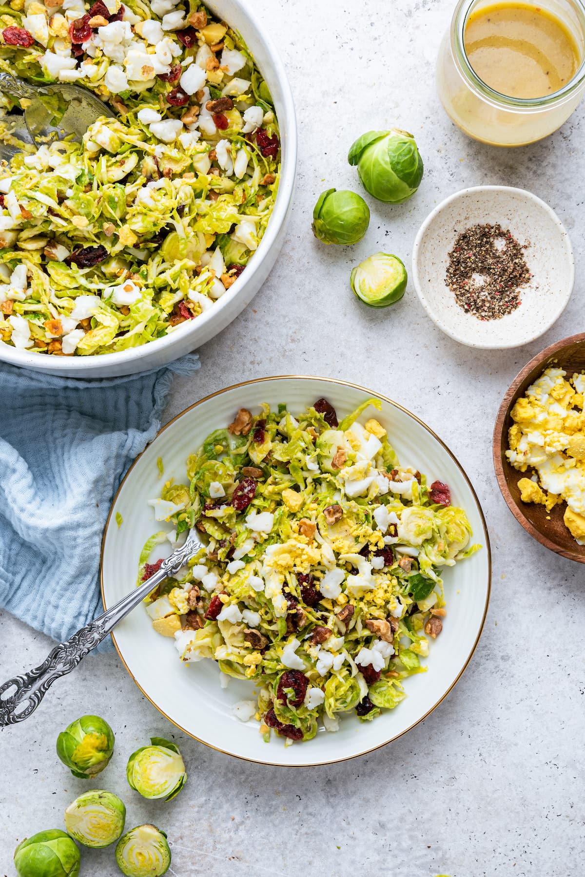 A white plate with a serving of the Brussels sprout chopped salad.