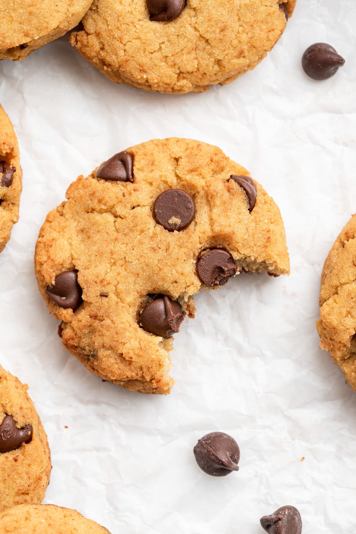 A coconut flour cookie with a bite taken out of it.