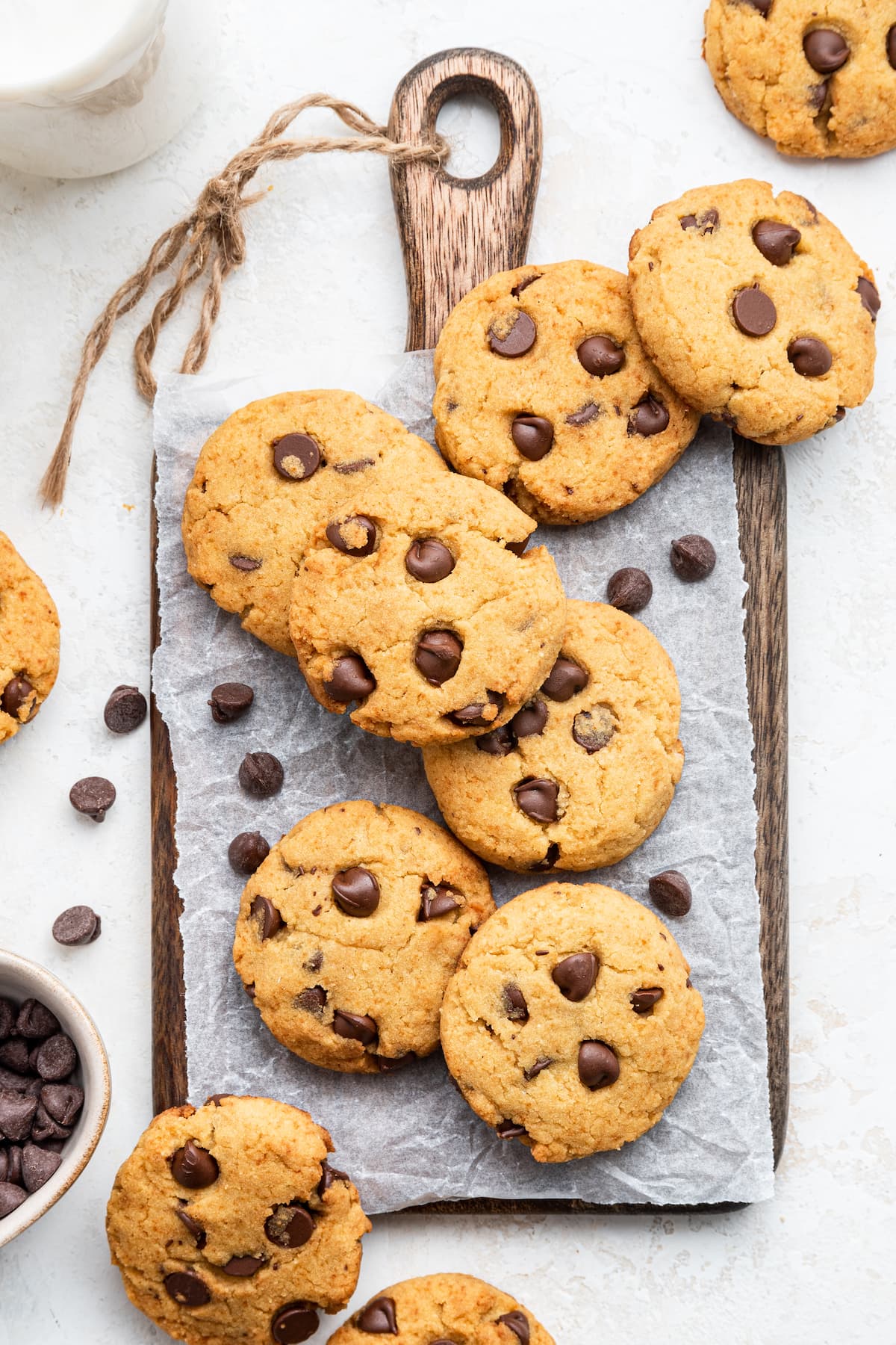 Coconut flour cookies spread out over a wooden cutting board.