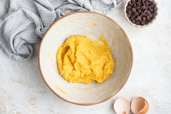 A white bowl containing coconut flour cookie dough.