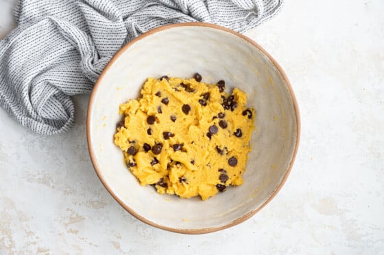 A white bowl containing coconut flour chocolate chip cookie dough.