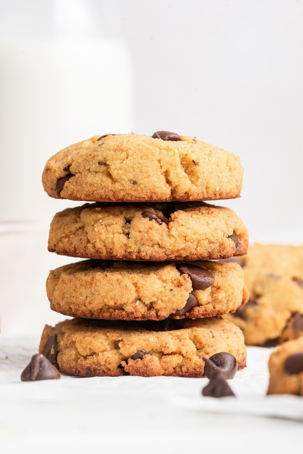 Four coconut flour chocolate chip cookies stacked on one another.