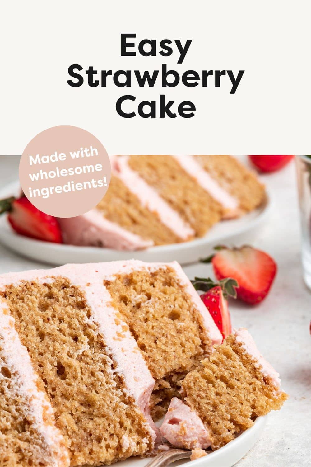 A slice of strawberry cake on a small white plate with a metal fork holding a piece of the slice.