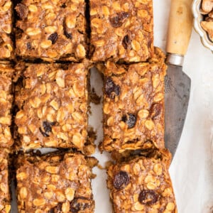 Six healthy banana oat bars with a metal serving spatula underneath one.