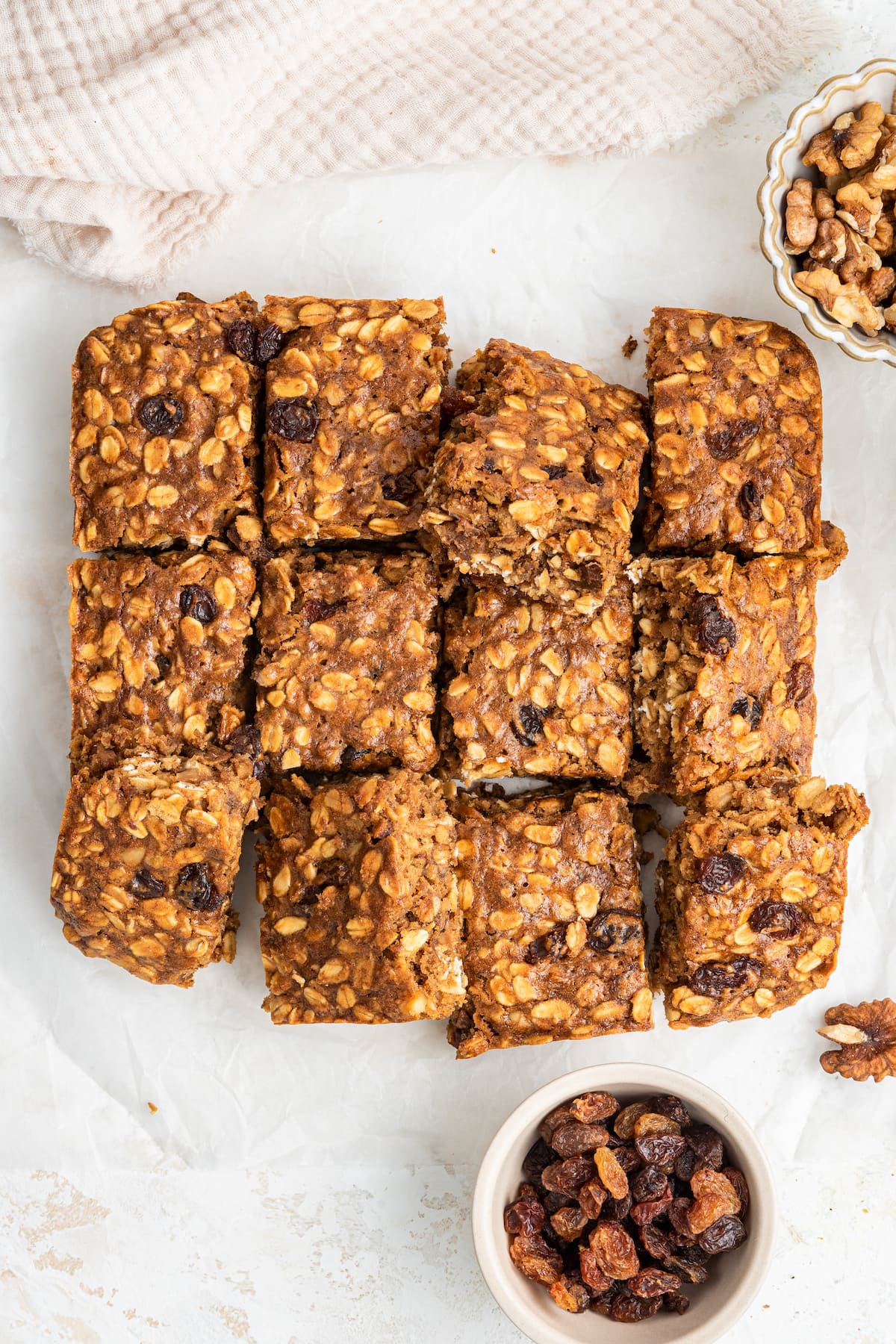Twelve healthy banana oat bars close together on the counter.