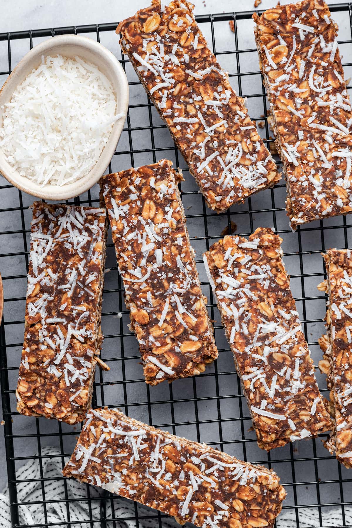 No-bake chocolate coconut bars on a wire rack.