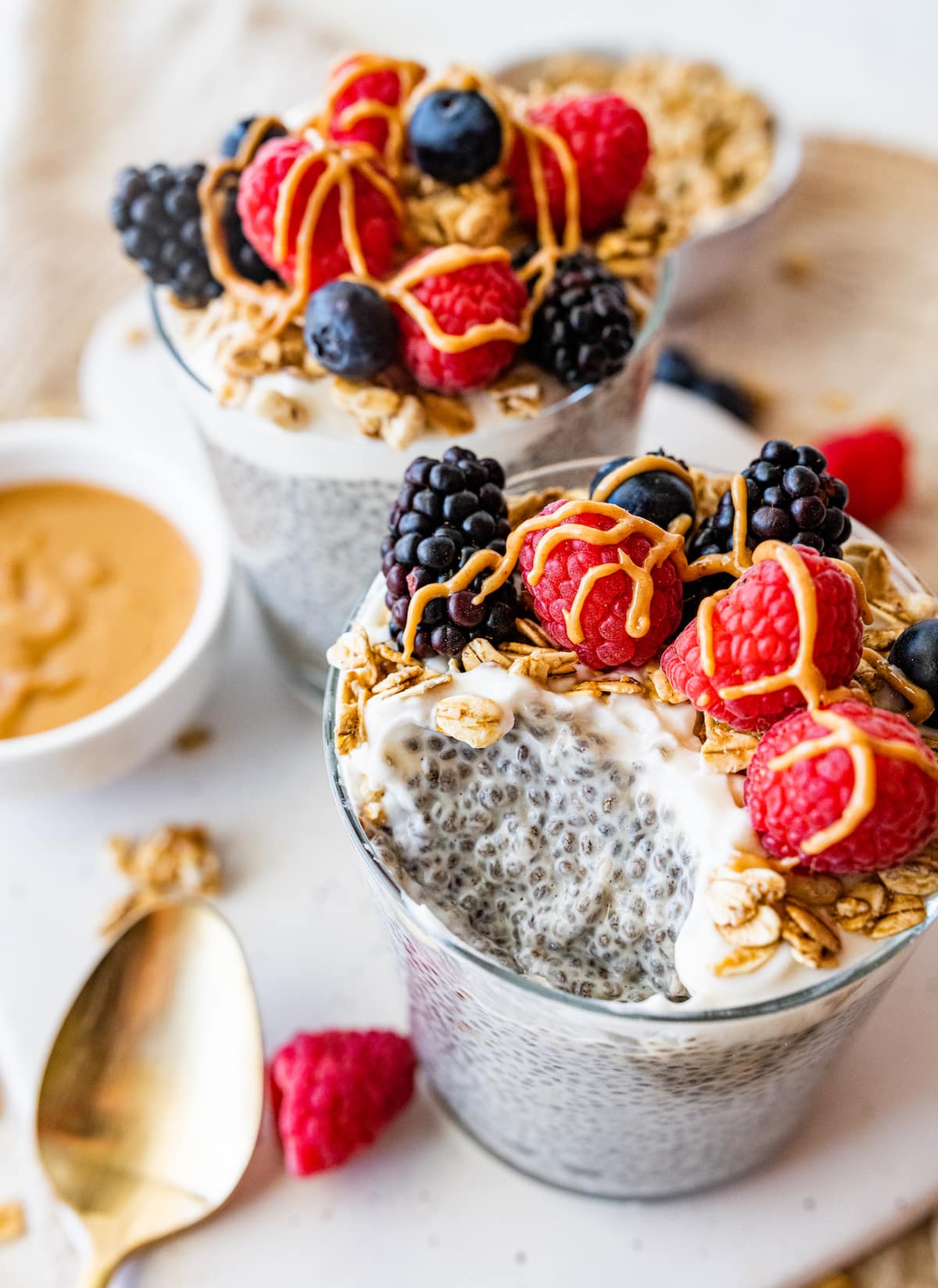 A jar of protein chia pudding with a bite removed.