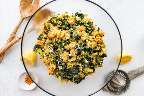 A glass bowl containing a roasted broccoli quinoa salad.