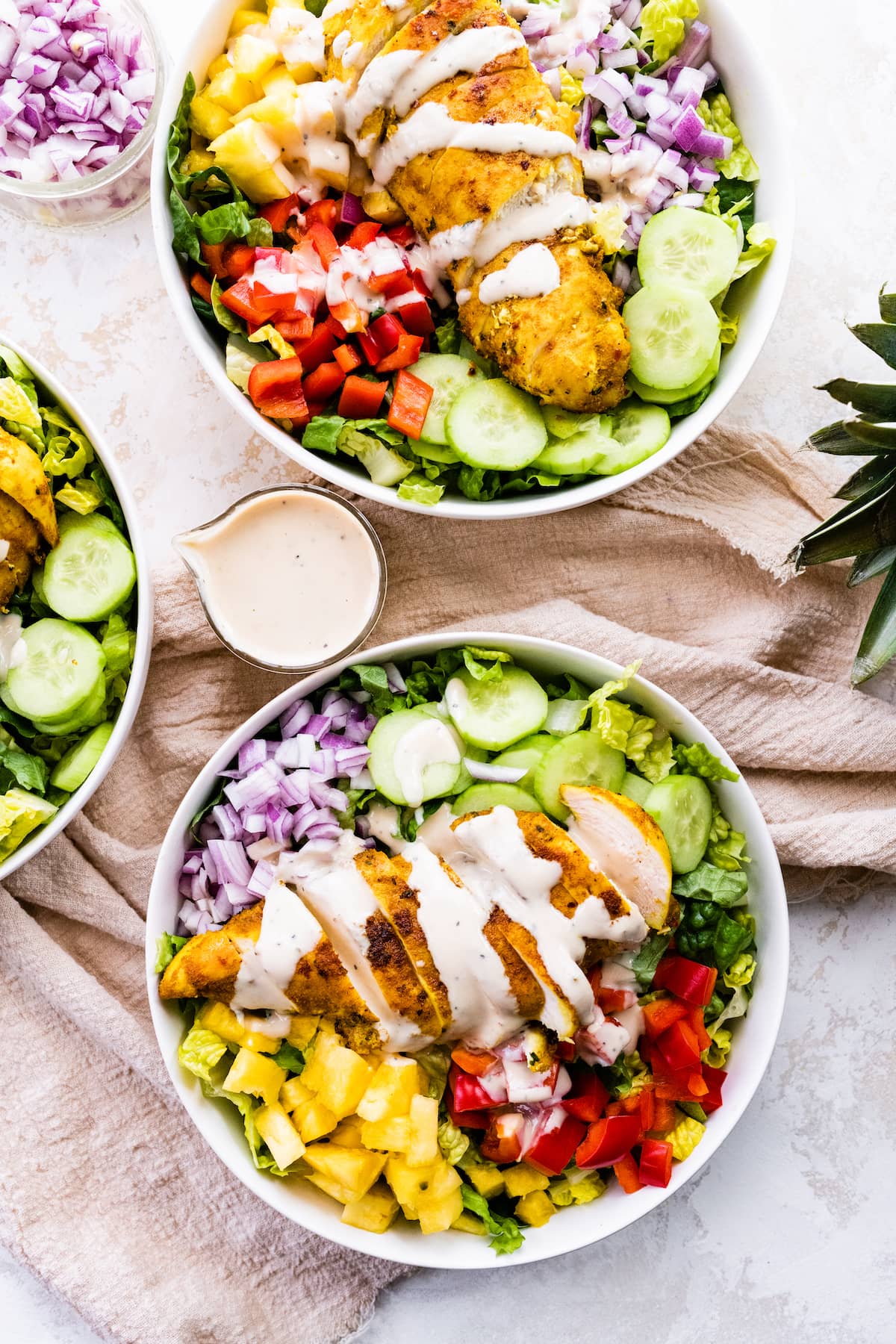 Two white bowls containing the Thai curry chicken salad with a creamy dijon dressing.