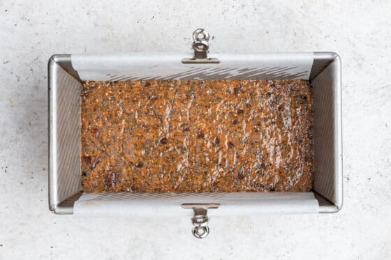 Coconut chia bar mixture in a rectangular bread pan.