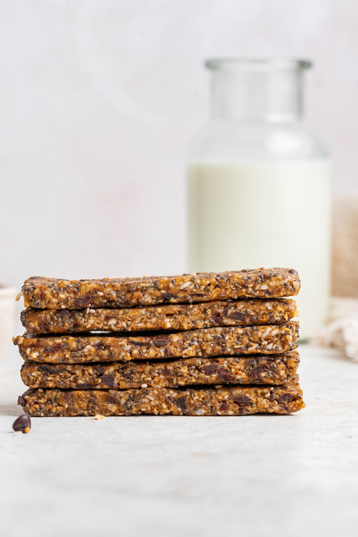 Five toasted coconut chia bars stacked on one another.