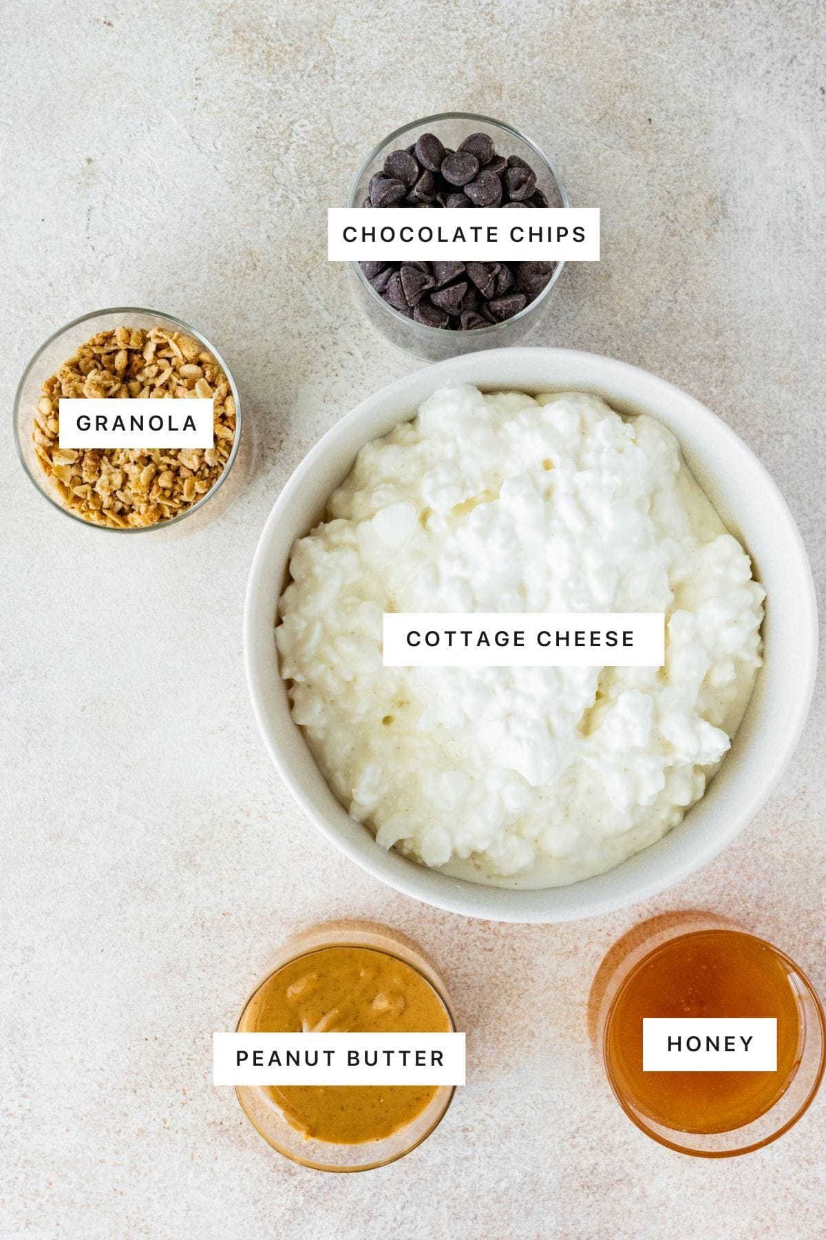 Ingredients for the frozen cottage cheese bark: cottage cheese, honey, peanut butter, granola and chocolate chips.
