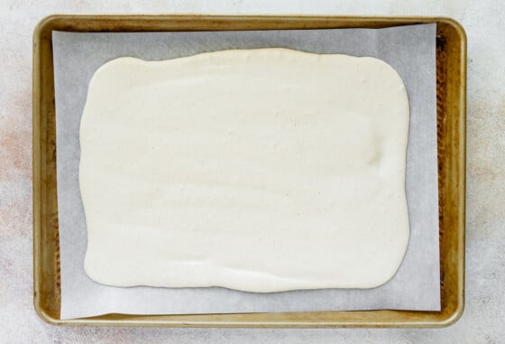 Cottage cheese bark mixture spread out onto a baking tray lined with parchment paper.
