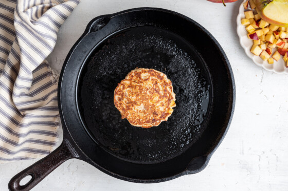 One pancake in a cast iron skillet.