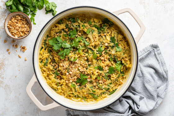 Healthy pad thai garnished with fresh cilantro in a large white pot.