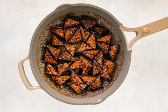 Maple balsamic cooked tempeh in a skillet.