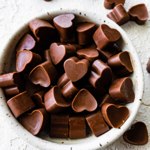 Heart-shaped poop chocolates in a small white bowl.