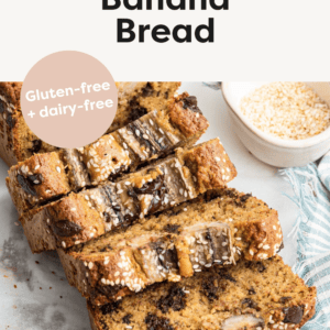 Four slices gently resting on one another in a domino-like formation falling away from the loaf of tahini banana bread.