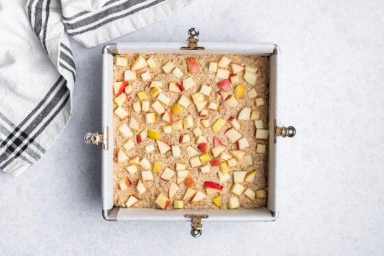 Apple oatmeal bars in a square baking pan before being baked.