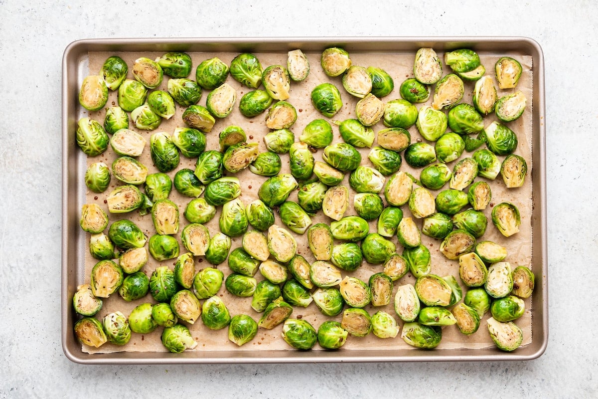 Balsamic Brussels Sprouts on a baking tray before being roasted.
