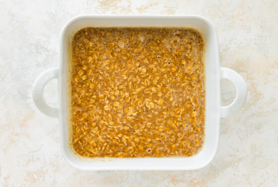 Coffee baked oatmeal in a square baking dish before being baked.