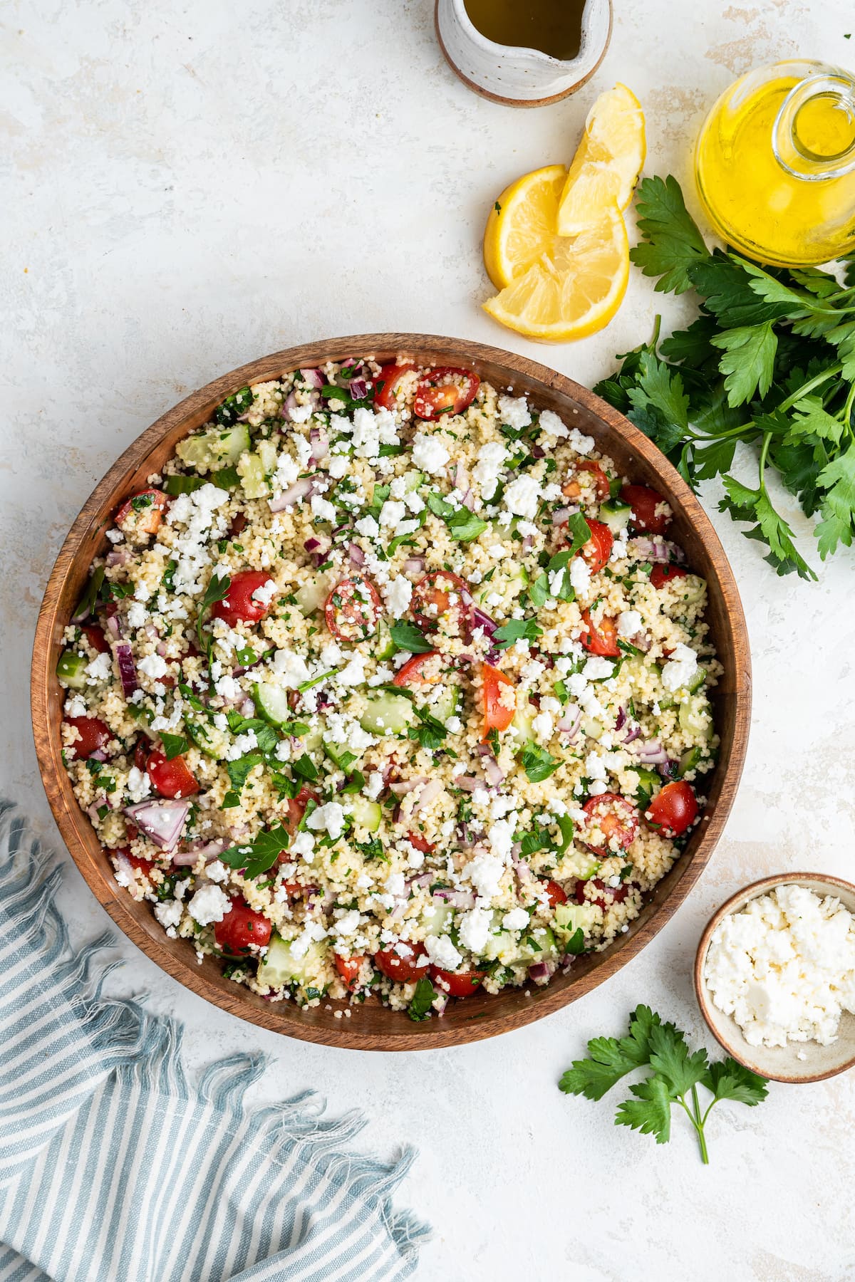 A couscous salad in a large wooden bowl.