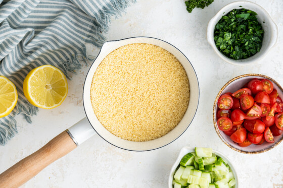 Cooked couscous in a large white pot.