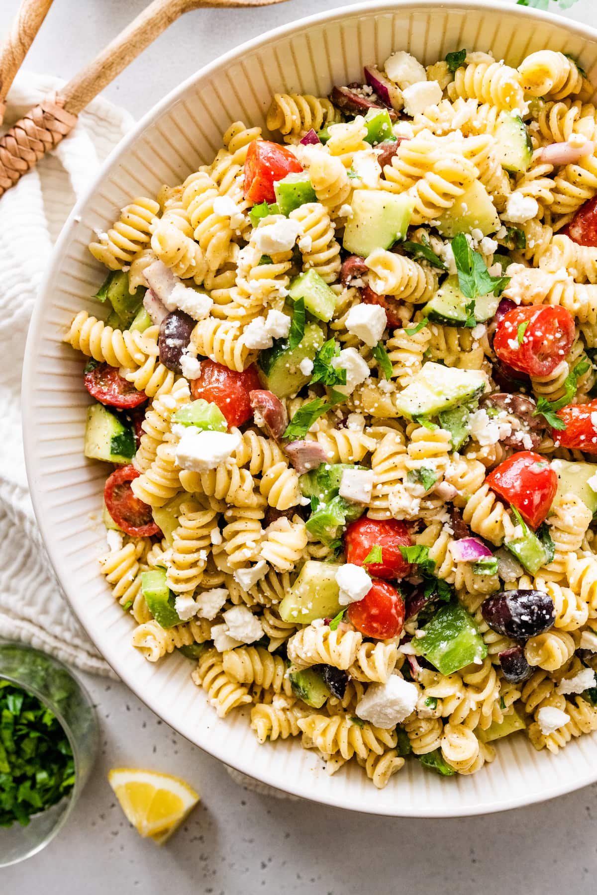 Greek pasta salad in a large white bowl.