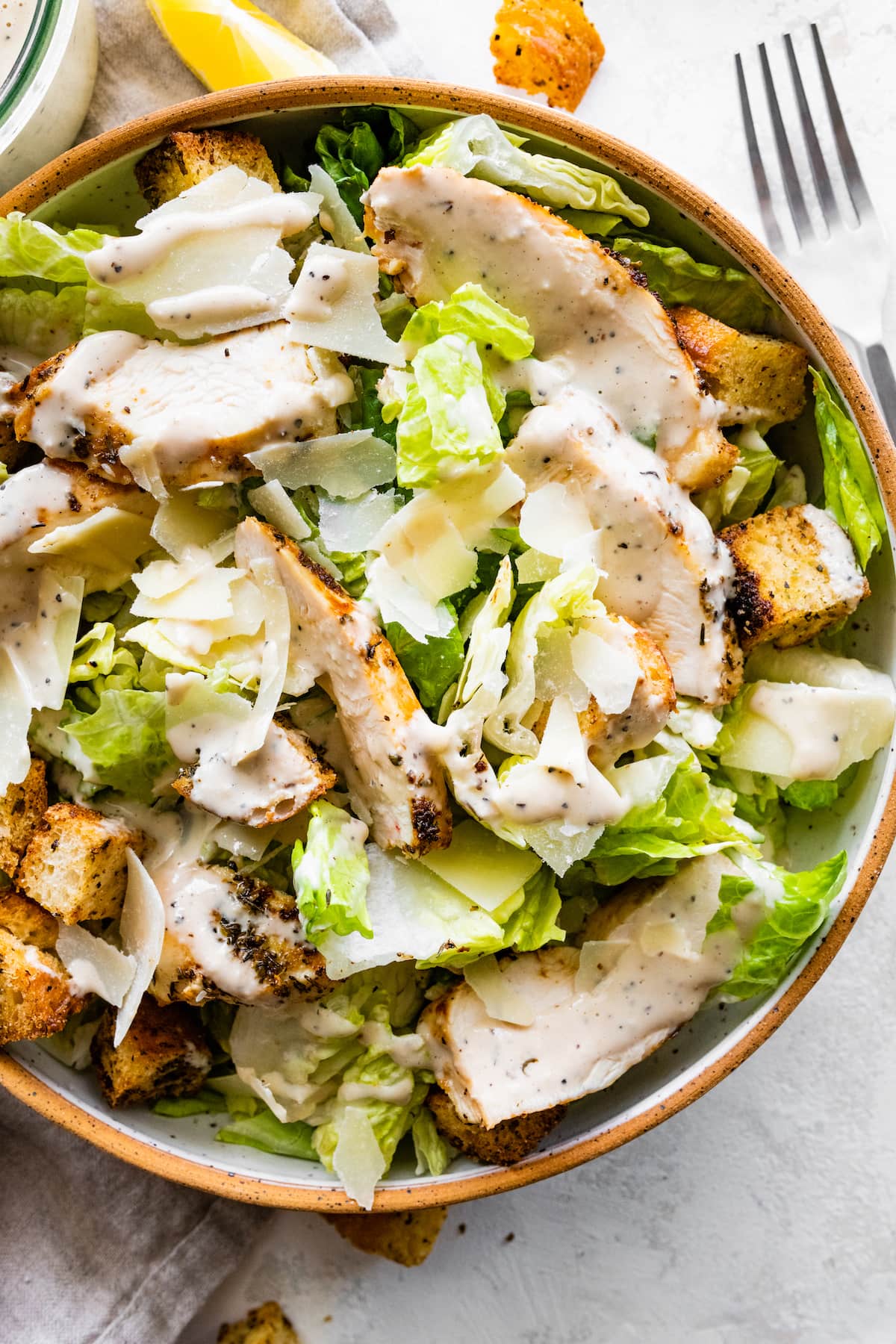 Grilled chicken Caesar salad in a bowl.