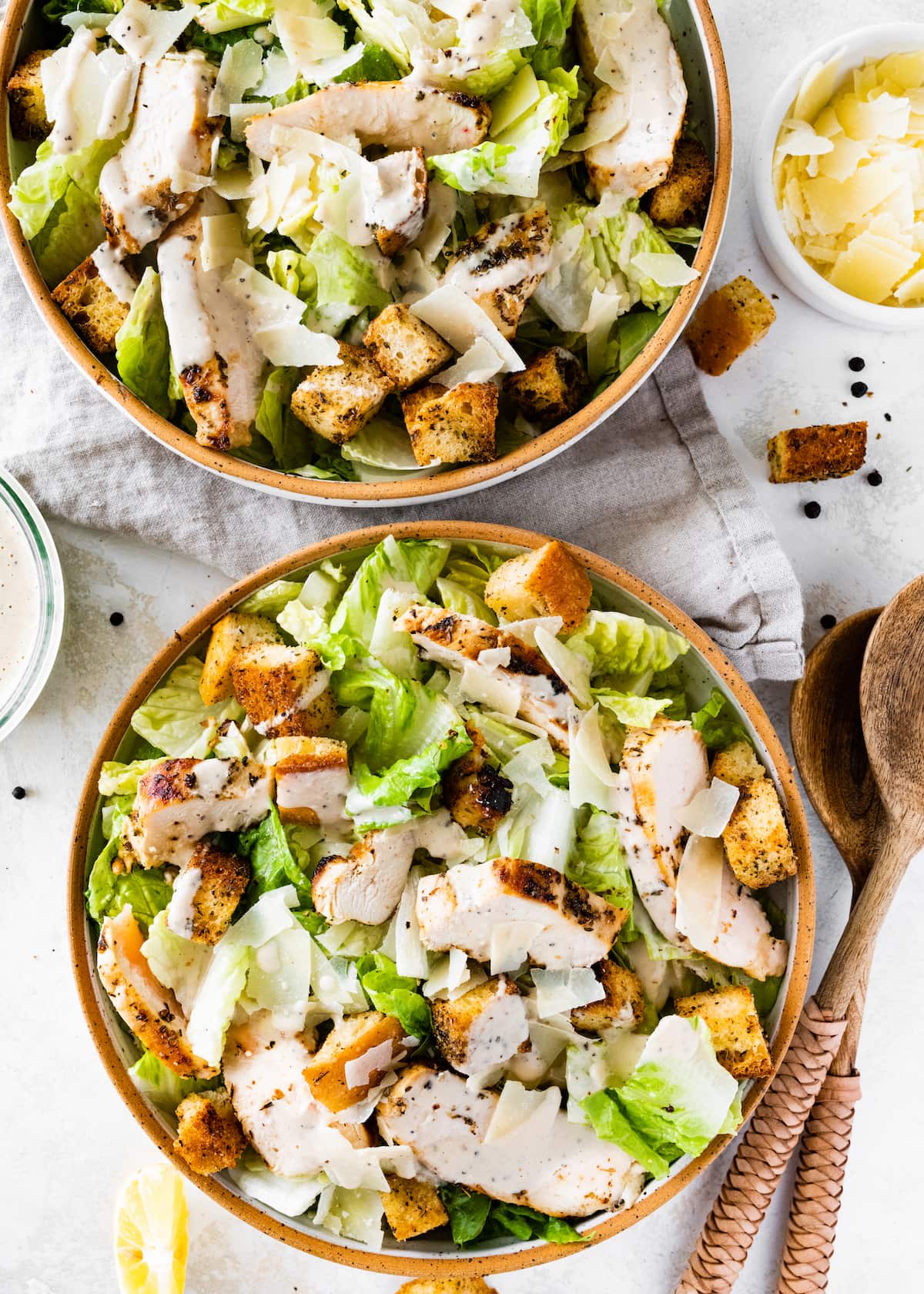 Grilled Chicken Caesar Salad in two separate bowls.