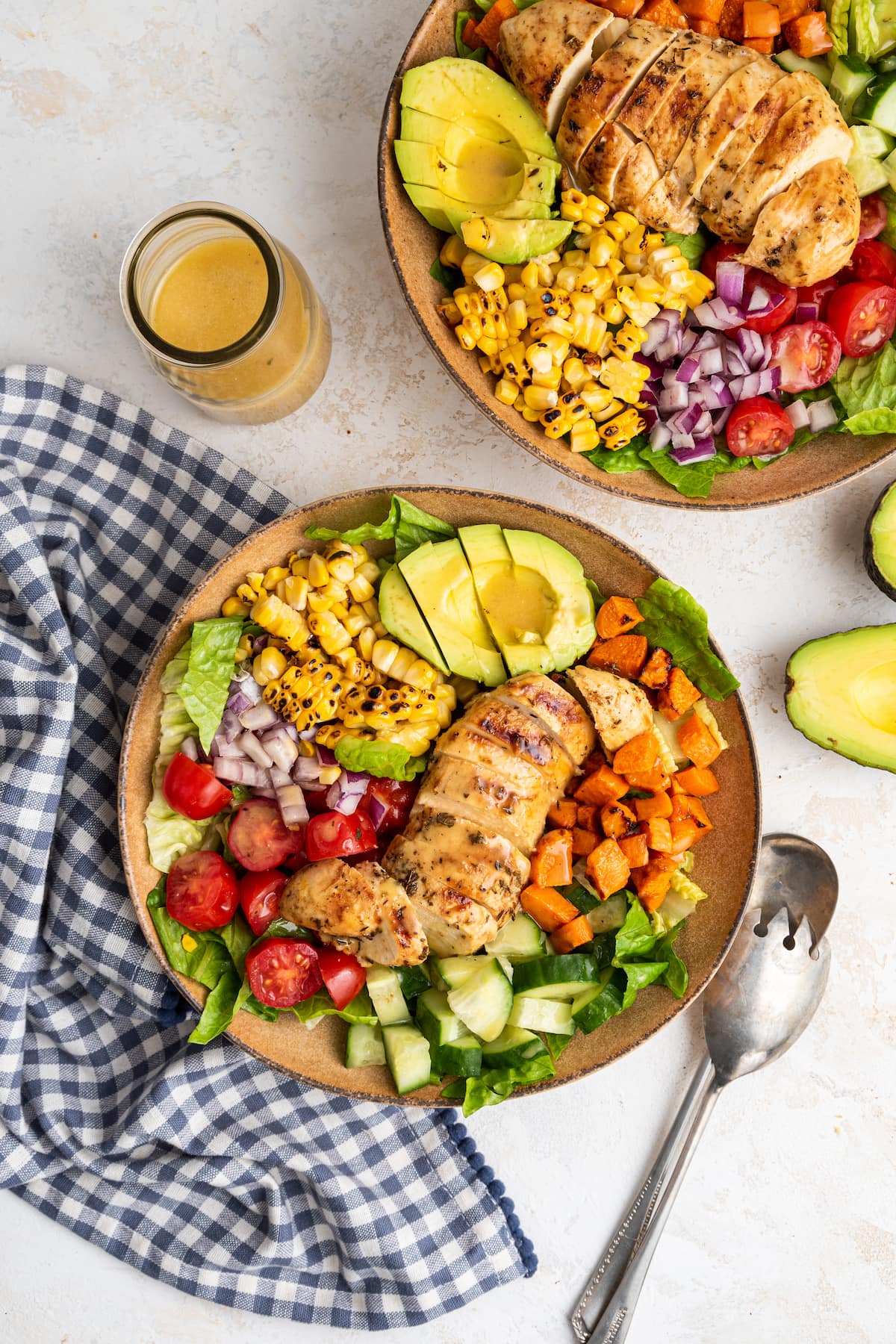 Two bowls of grilled chicken salad.