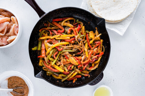 Cooked onion and bell pepper in a cast iron skillet.