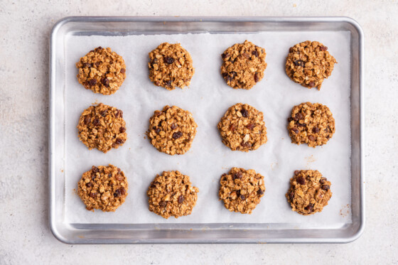 Twelve oatmeal breakfast cookies on a baking tray.