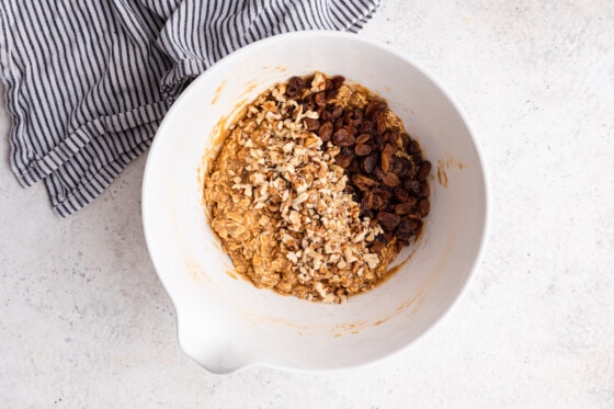 Ingredients mixed together in a large mixing bowl for the oatmeal breakfast cookies with raisins added.