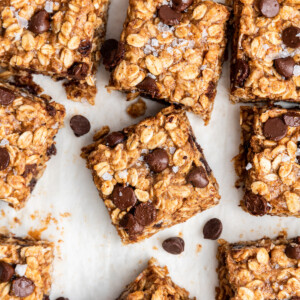 Multiple oatmeal chocolate chip bars on parchment paper.