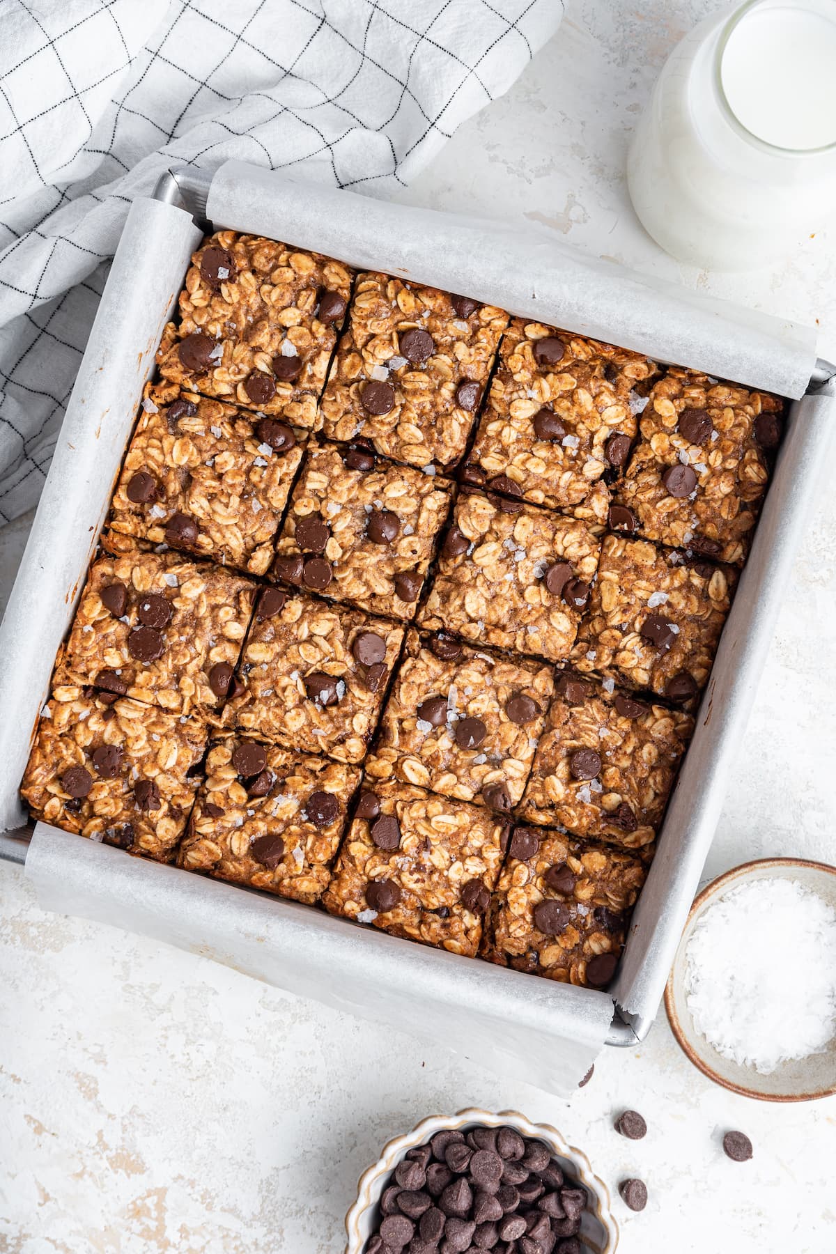 Oatmeal chocolate chip bars in a square baking pan.