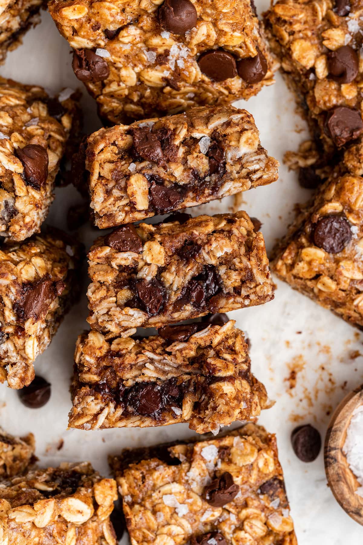 Multiple oatmeal chocolate chip bars on parchment paper.