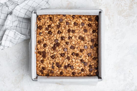 Oatmeal chocolate chip bars in a square baking pan.