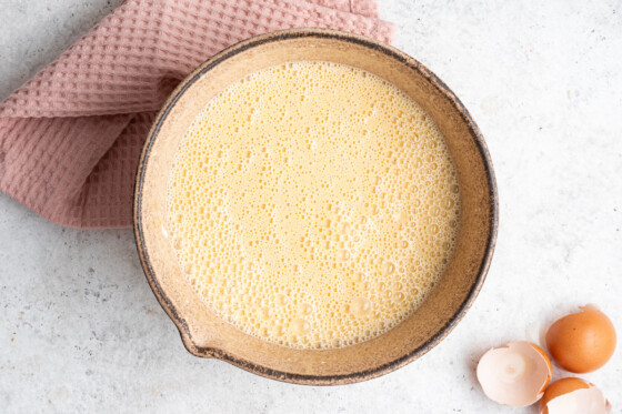 The wet ingredients for the vanilla cake in a large mixing bowl.