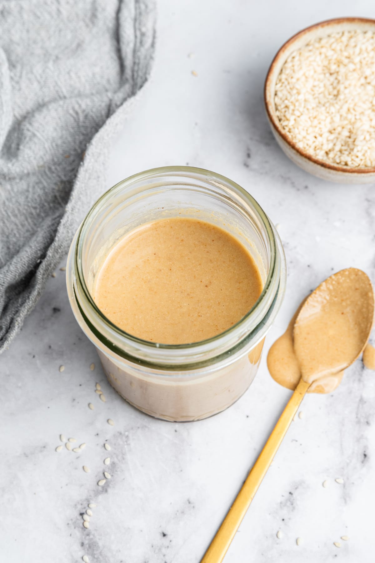 Tahini in a glass mason jar.