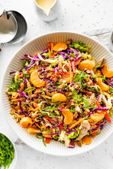 Mandarin orange chicken salad in a large white serving bowl.