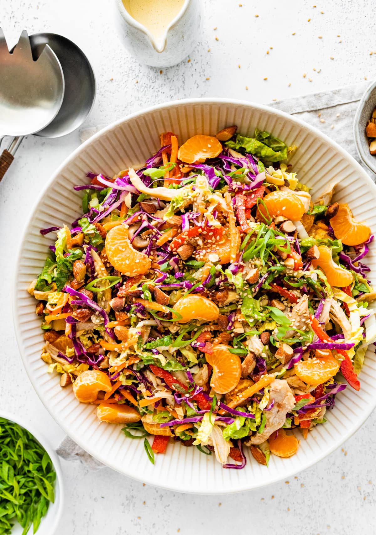 Mandarin orange chicken salad in a large white serving bowl.