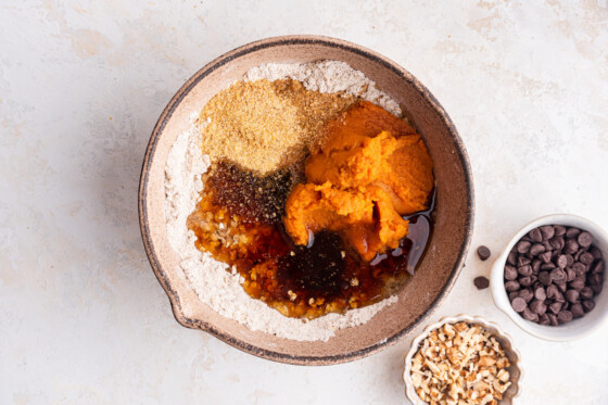 All the ingredients for the pumpkin oatmeal bars in a large mixing bowl before being combined.