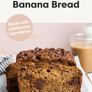 A loaf of zucchini banana bread that has just been cut to see the inside of the bread.