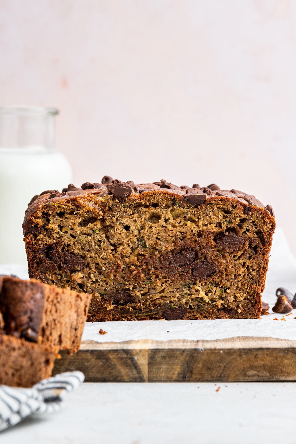 A loaf of zucchini banana bread that has just been cut to see the inside of the bread.